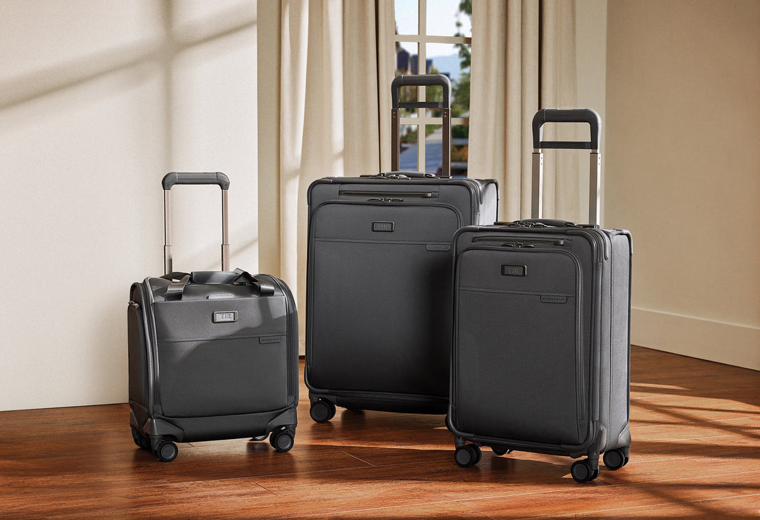 Grey Baseline Luggage Collection on hardwood floors