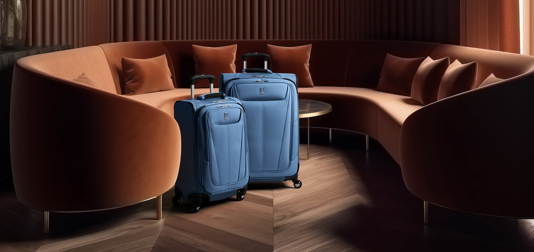 Travelpro Maxlite 5 luggage sits in hotel lobby next to orange couch