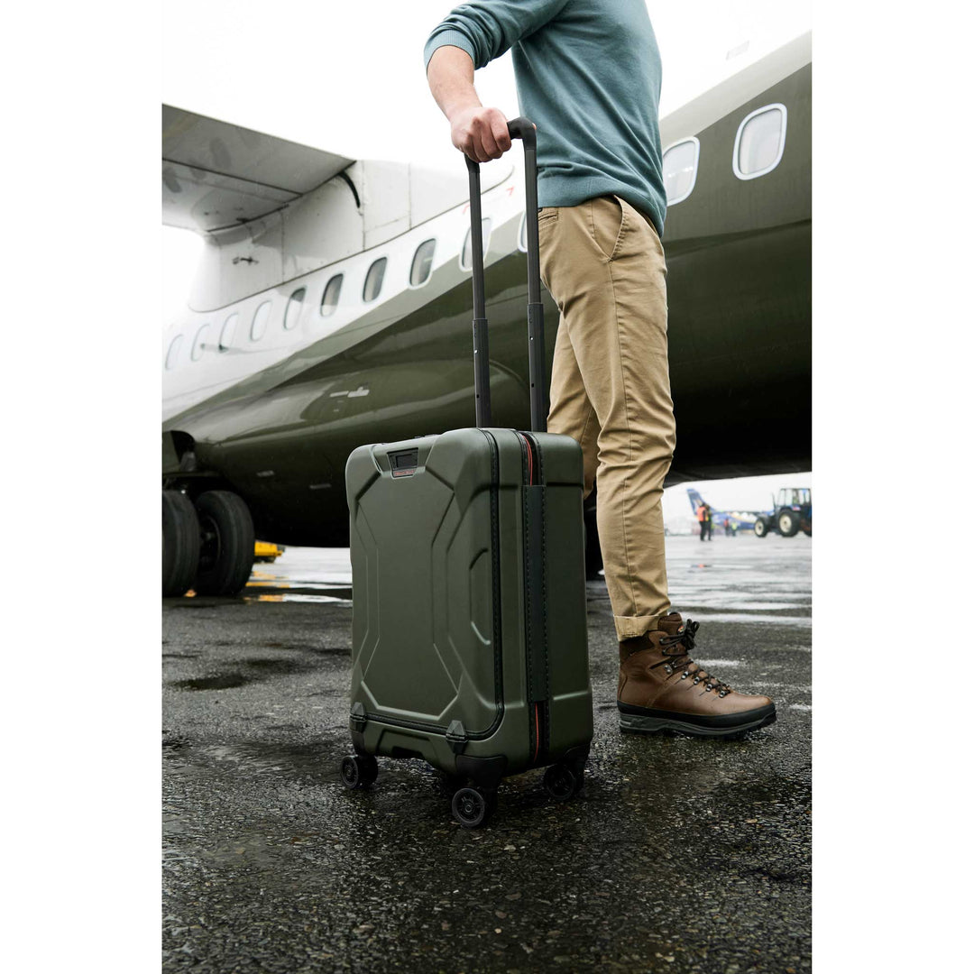 Man boarding green airplane with hunter torq carry on suitcase