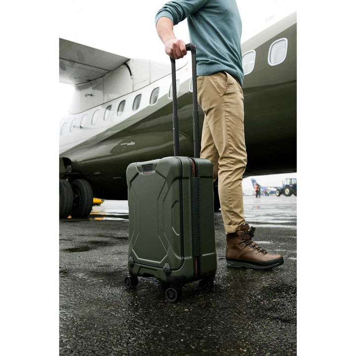 Man boarding green airplane with hunter torq carry on suitcase