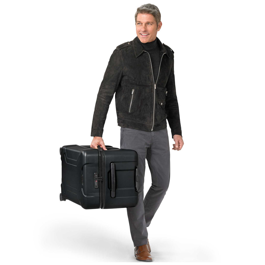 Man carrying extra large black luggage hardside with luggage lock