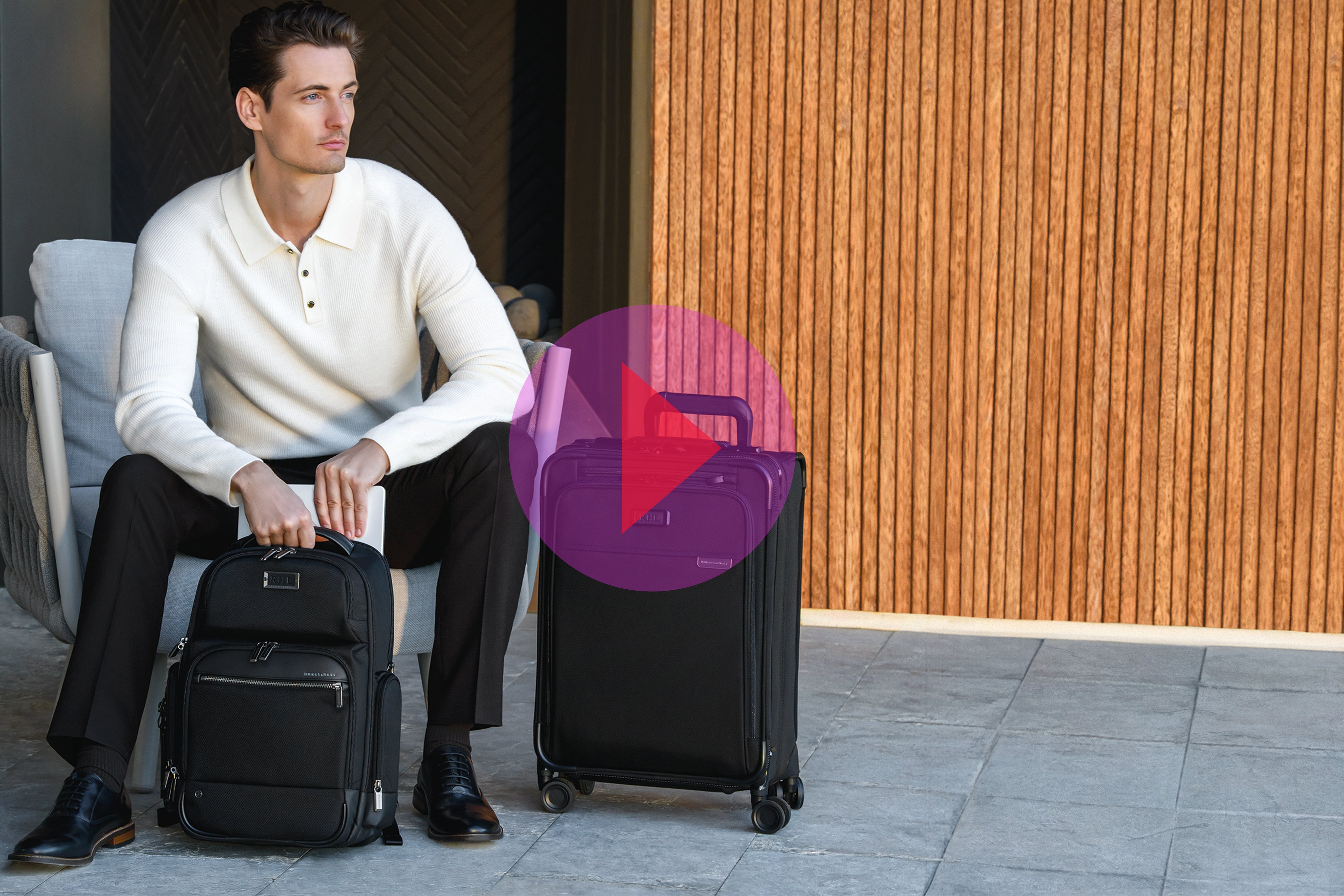 Man sits in hotel with luggage waiting for taxi