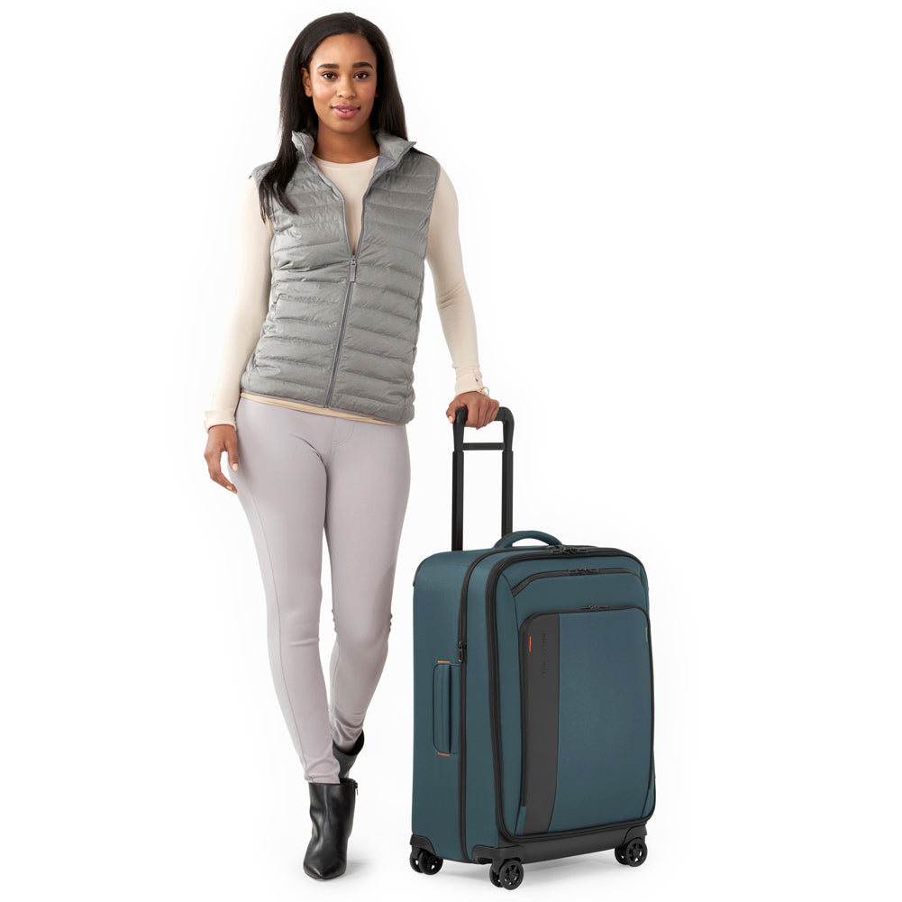 Woman Models Briggs & Riley ZDX Medium Expandable Spinner in color Ocean Blue