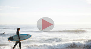 Man with surfboard at beach video