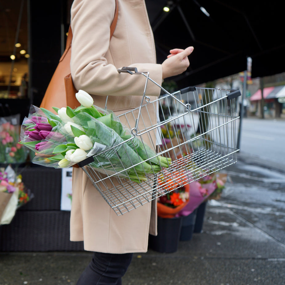 Woman buys tulips from outdoor store at Stanford open air mall