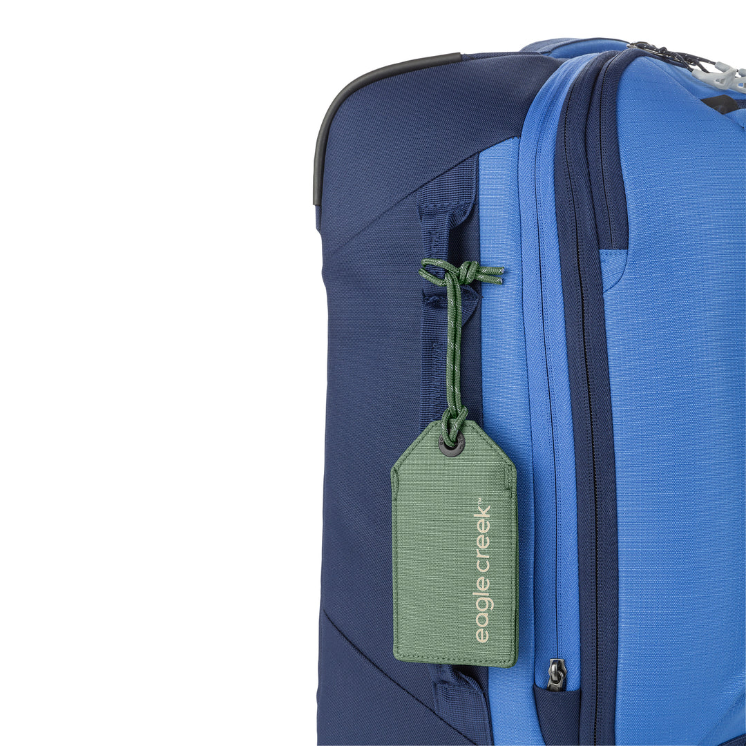 Eagle Creek Reflective Luggage Tag color green hanging on blue suitcase