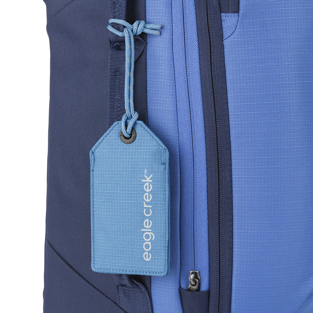 Eagle Creek Reflective Luggage Tag Baby Blue color on bright blue suitcase