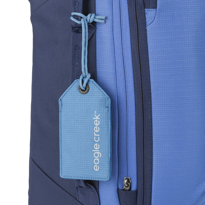 Eagle Creek Reflective Luggage Tag Baby Blue color on bright blue suitcase