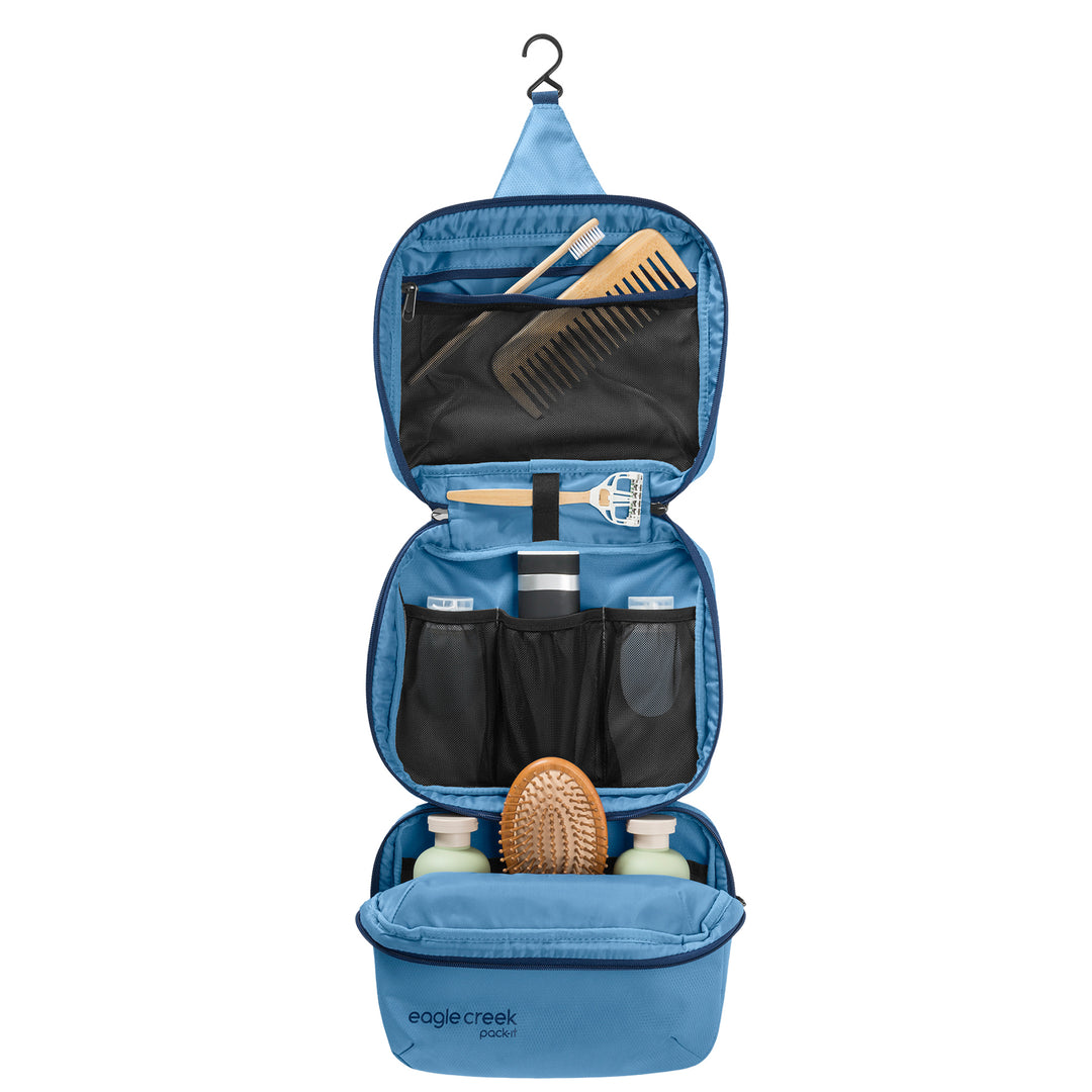 Trifold Toiletry Kit Hanging open packed with hair brush shampoo razor comb and toothbrush
