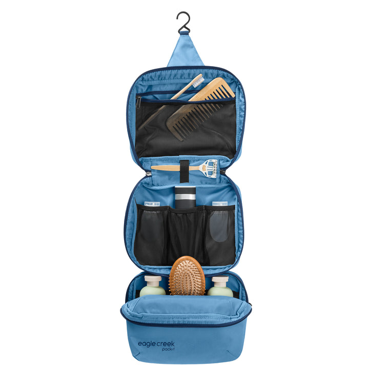 Trifold Toiletry Kit Hanging open packed with hair brush shampoo razor comb and toothbrush