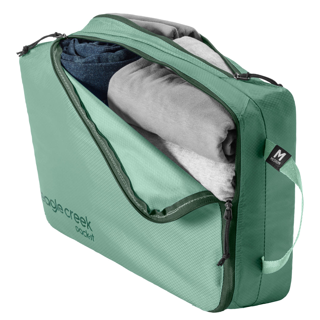 Medium Packing Cube in Willow Green packed up with shirts and jeans