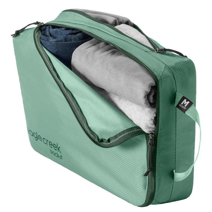 Medium Packing Cube in Willow Green packed up with shirts and jeans
