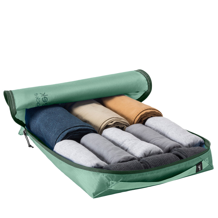 Large packing cube packed up with pants shirts and socks in color Willow Green