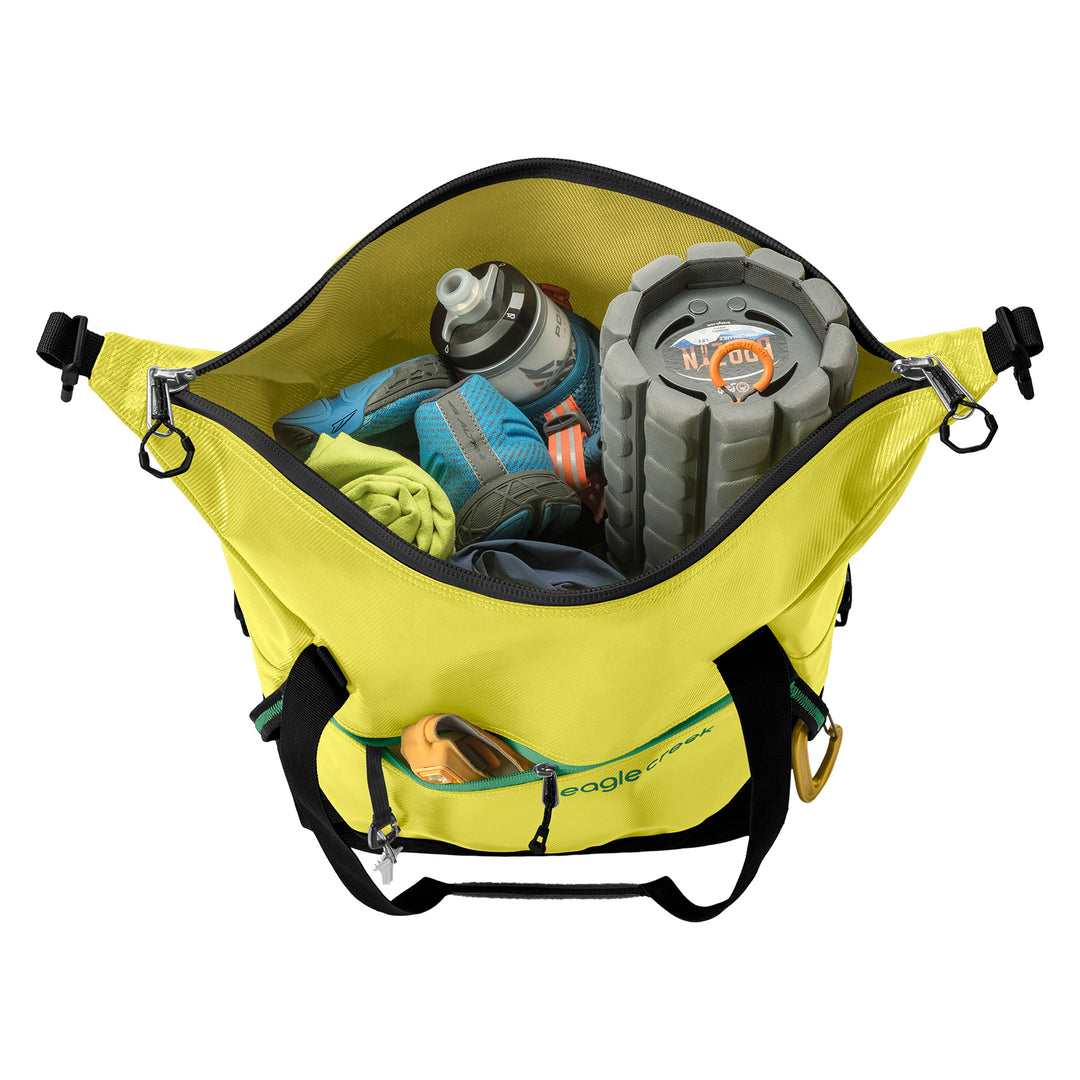Fully packed with workout gear Eagle Creek Migrate Tote Bag in color highlighter yellow