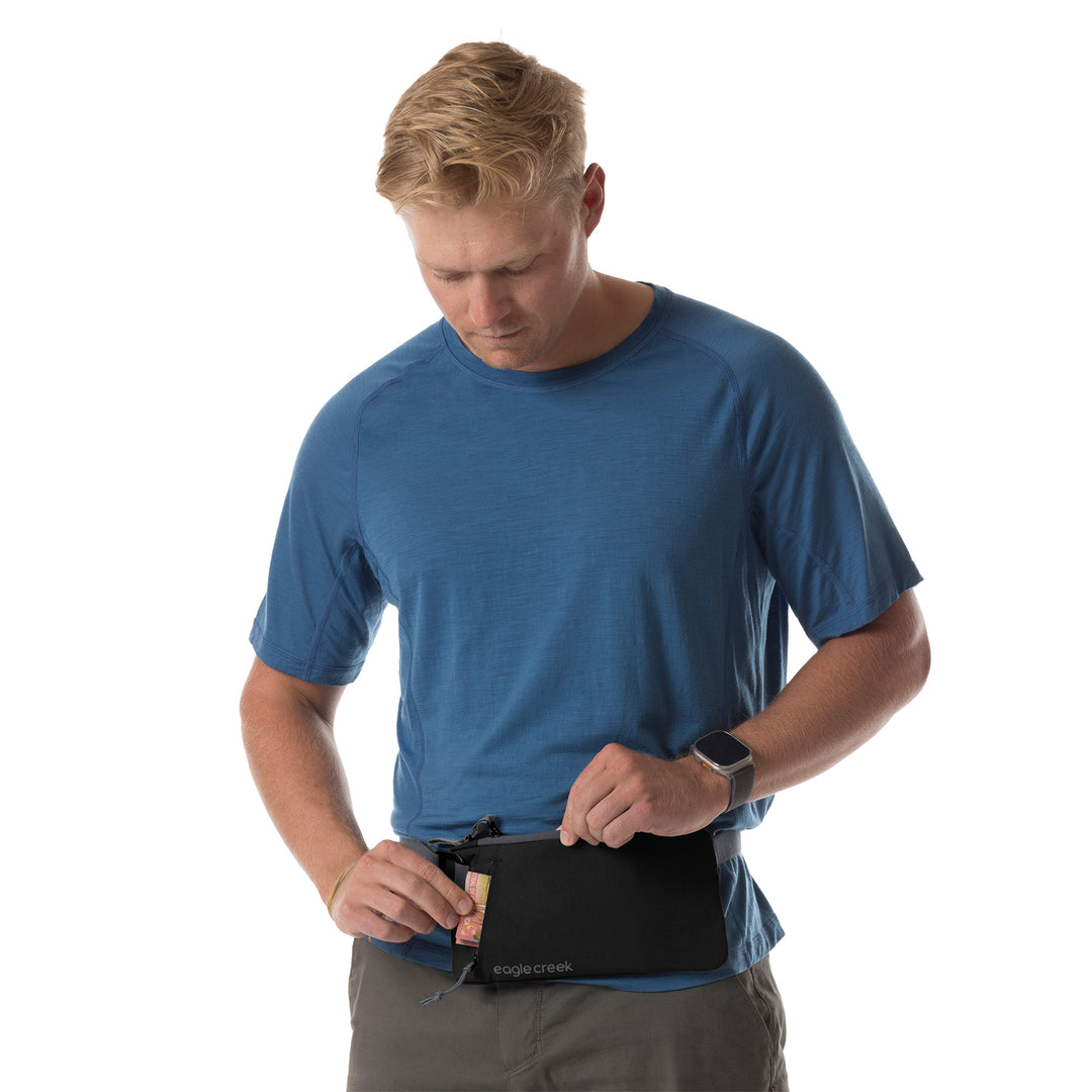 Man wearing Black Eagle Creek Stash RFID Sling Bag around waist with cash