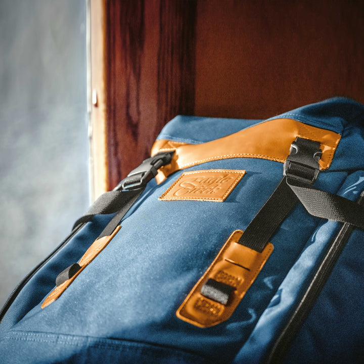 Close up of Classic Blue Eagle Creek Origin Series Klettersack Backpack with leather touch points