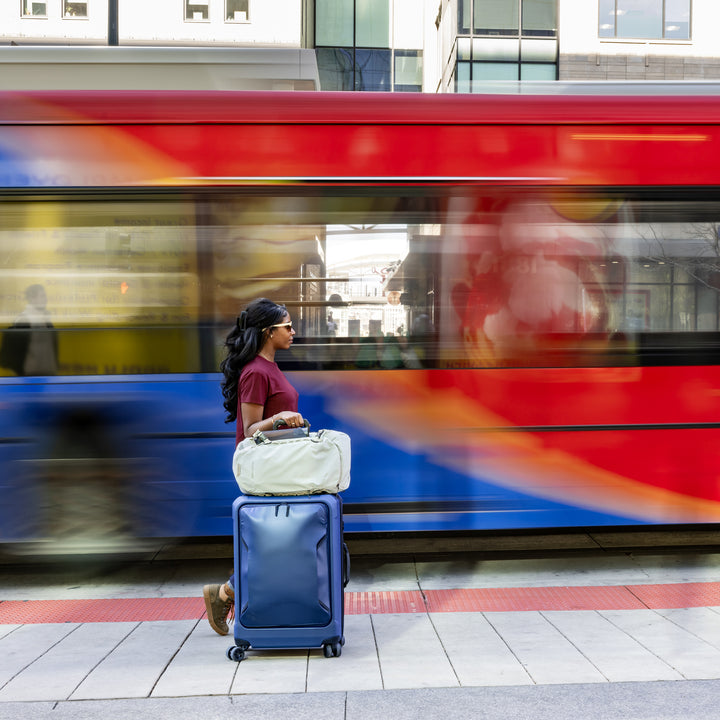 Woman wheels her Eagle Creek Luggage through the Denver Airport