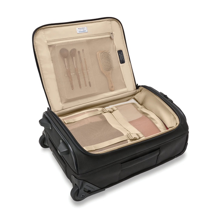 Interior of Baseline Global Two Wheel Carry On Duffel Bag with brush and makeup brushes