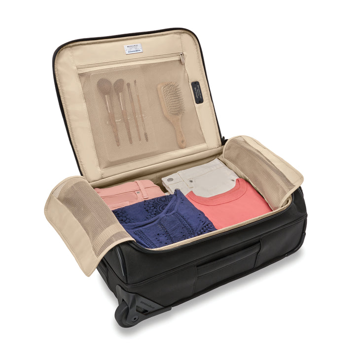 Interior of carry on duffel bag packed with shirts and shorts