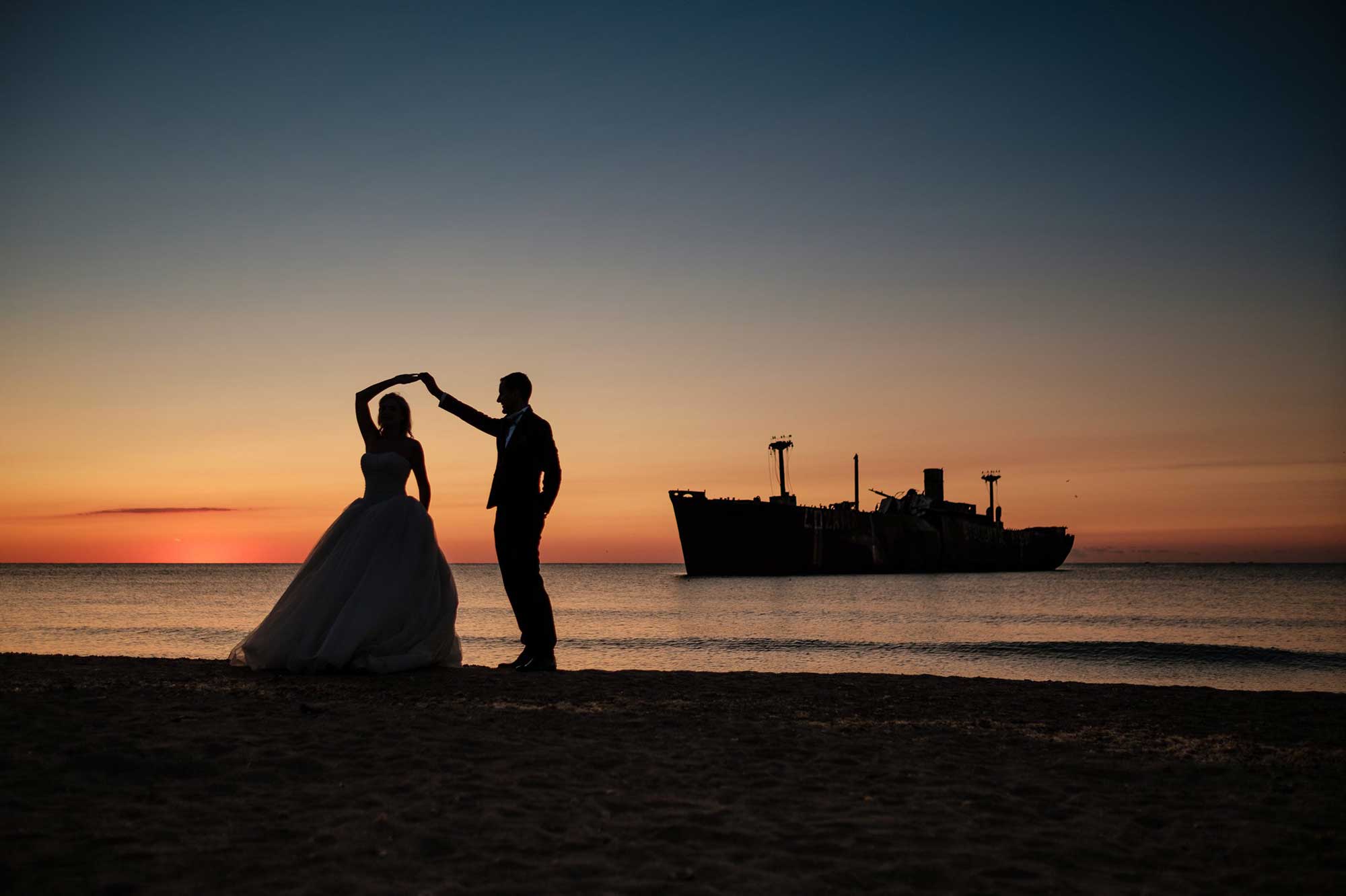 Newlyweds at sunset on beach