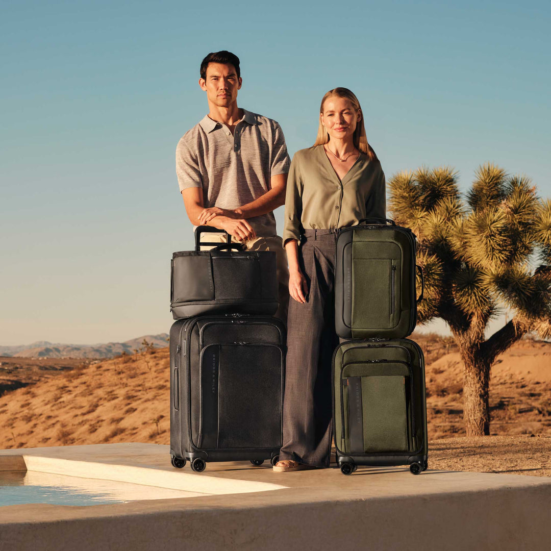 Couple check out of desert resort with ZDX luggage ready to go
