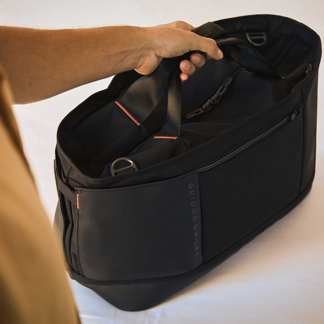 Man carries Overnighter ZDX bag by top handle