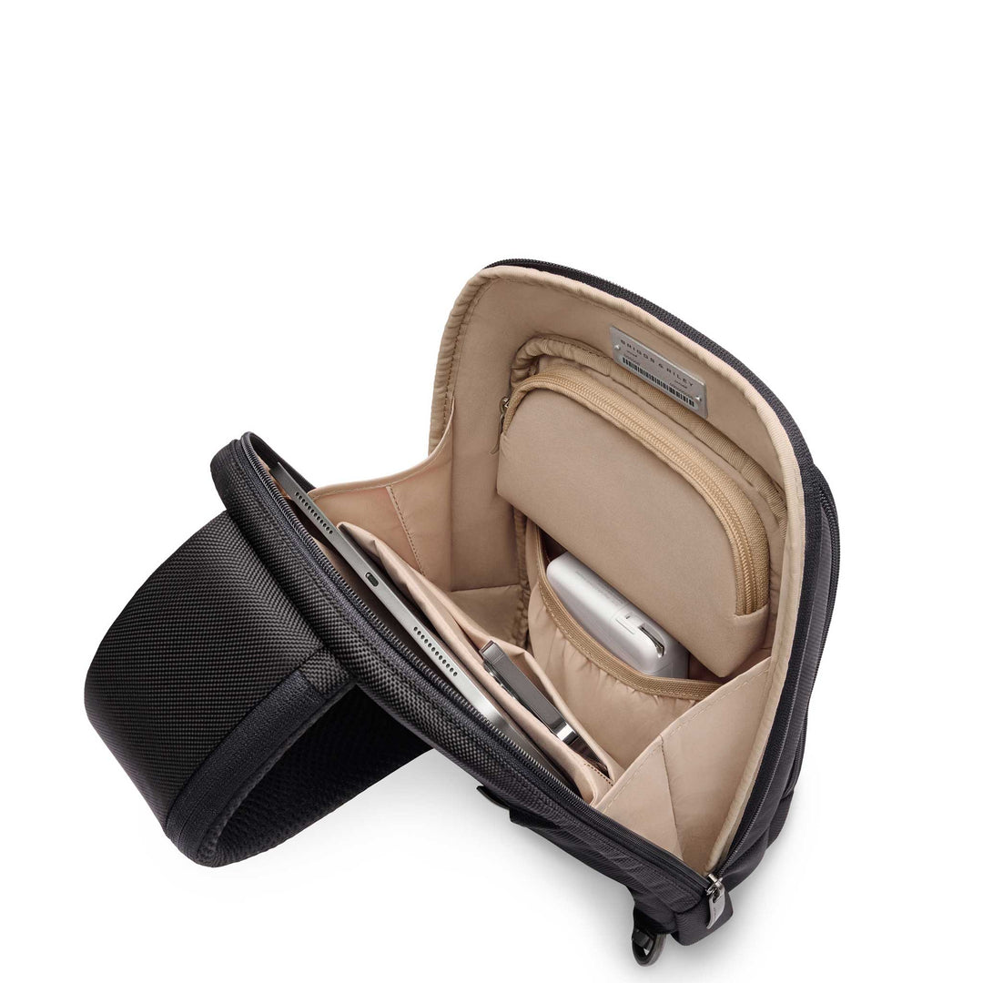 Interior of sling with ipad, charger and accessories