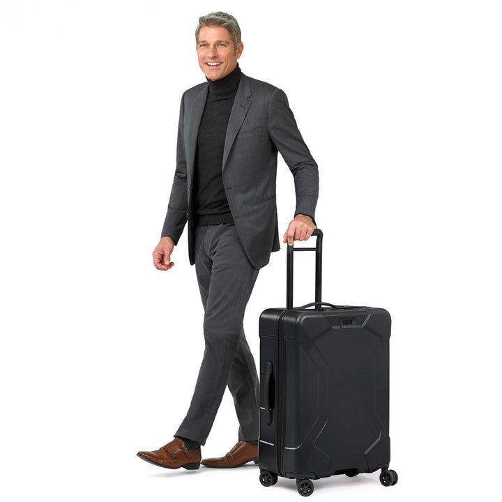 Black Briggs & Riley Torq Medium Spinner with male model in suit