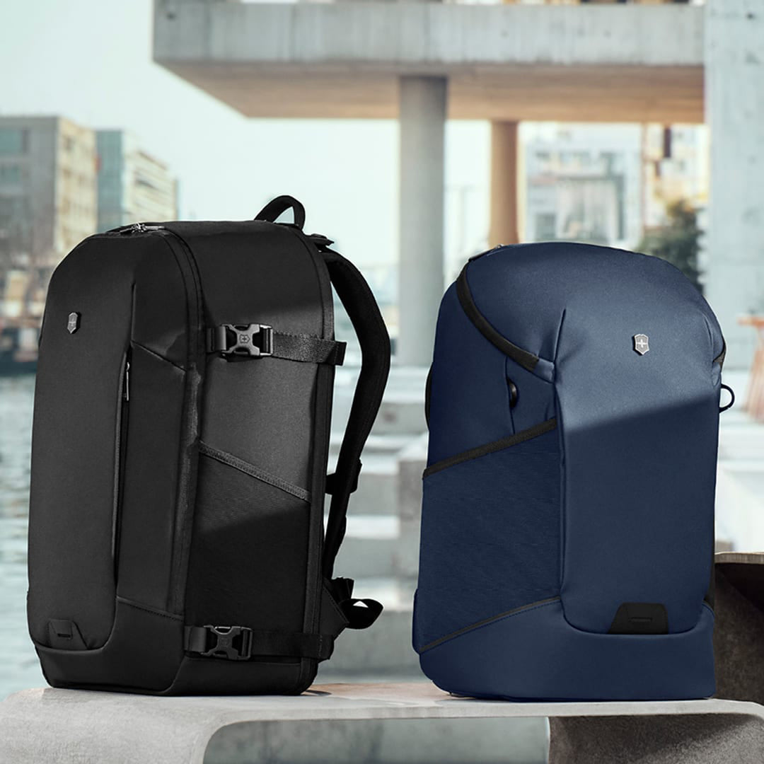Swiss Army backpacks in blue and black sitting on bench overlooking water in Foster City, CA