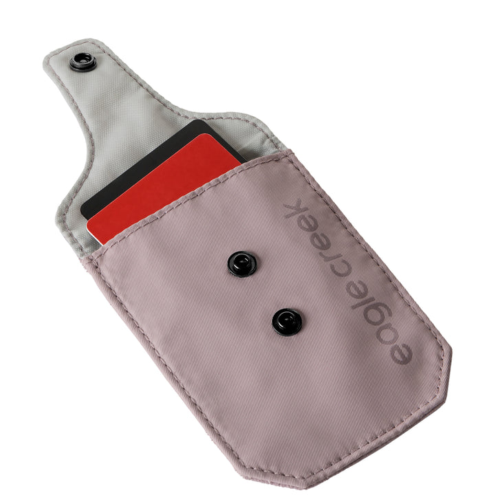 Eagle Creek Undercover RFID Bra Pouch color pink open with grey lining shown holding credit cards