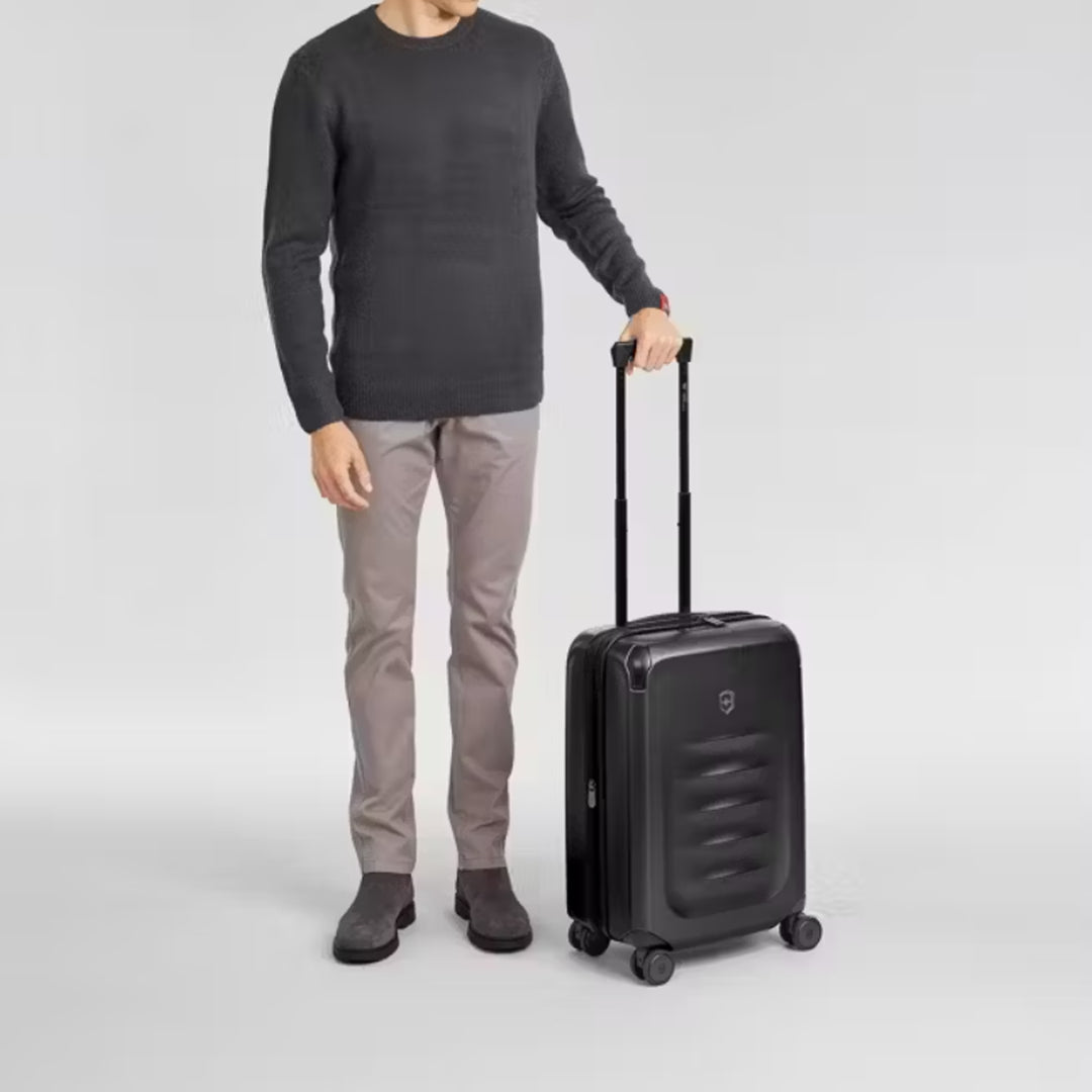 Man stands next to Victorinox Spectra 3.0 Frequent Flyer Plus Carry-On for size comparison