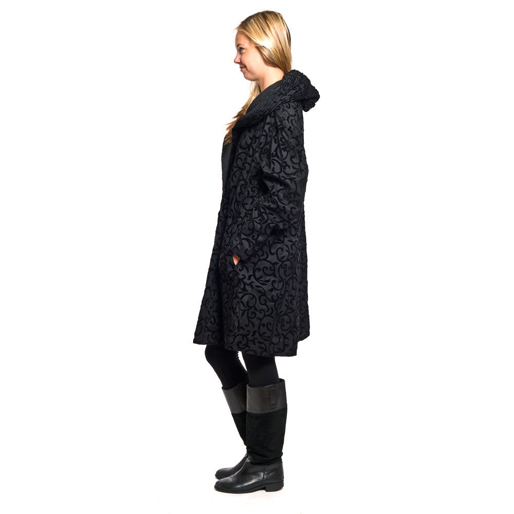 Model wearing Mycra Pac black scroll with rainboots